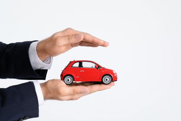 root car insurance features car insurance man in black suit holding red toy car in palm 
